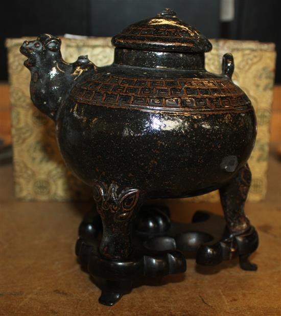 Chinese glazed teapot on stand in a case
